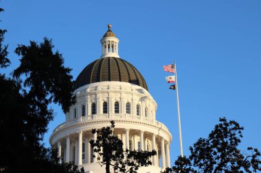 The famous California State Capitol Museum against a blue sky on a sunny day clipart