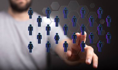 A businessman tapping on a digital render of an interconnected network of profile icons