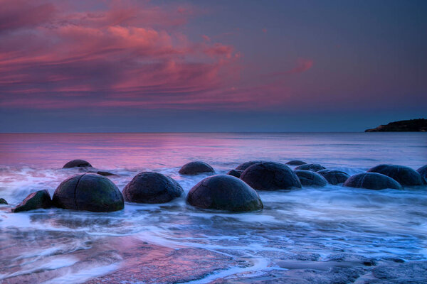 Moeraki boulders afterglow sunset on Koekohe beach, New Zealand