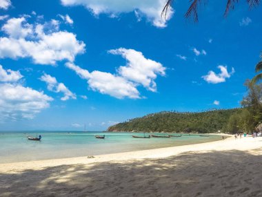 A beautiful beach with boats in Ko Pha-ngan, Thailand
