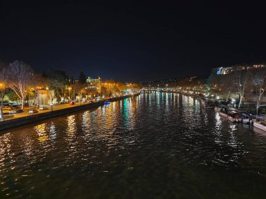 The view of the Mtkvari River and city lights at night. Tbilisi, Georgia.