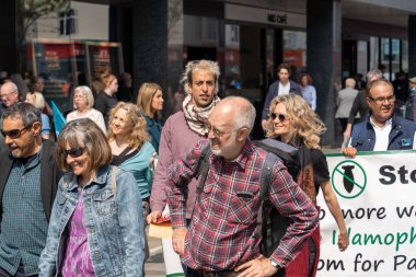 İnsanlar bir Mayıs yürüyüşüne katılıyor, işçi hakları, eşitlik, NHS için kampanya yapıyor ve barış umutlarını paylaşıyor.