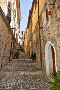 A narrow alley between the old houses of the medieval village of Giuliano di Roma