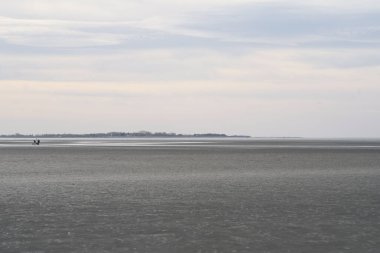 An idyllic sea with the coast in the background with a color splash effect