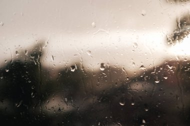 A closeup shot of raindrops on a wet window surface