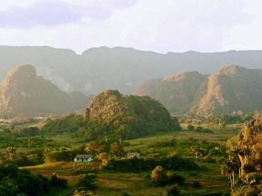 horizontal view of the vinales valley in cuba, beautiful soft lights from the sunset that provide an ethereal atmosphere
