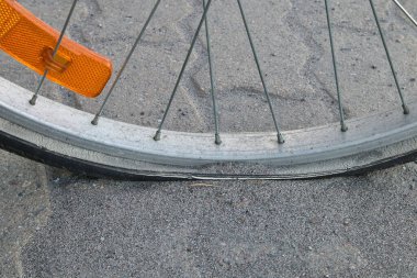 Flat bicycle tyre on sidewalk