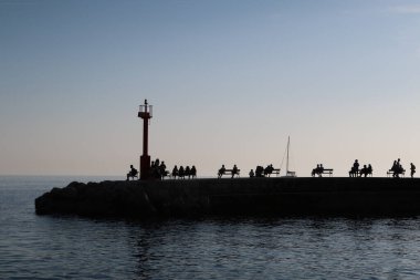 The silhouette of tourists on a pier during the sunset in Dubrovn