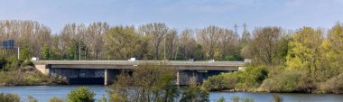 A panoramic view of a bridge surrounded by trees