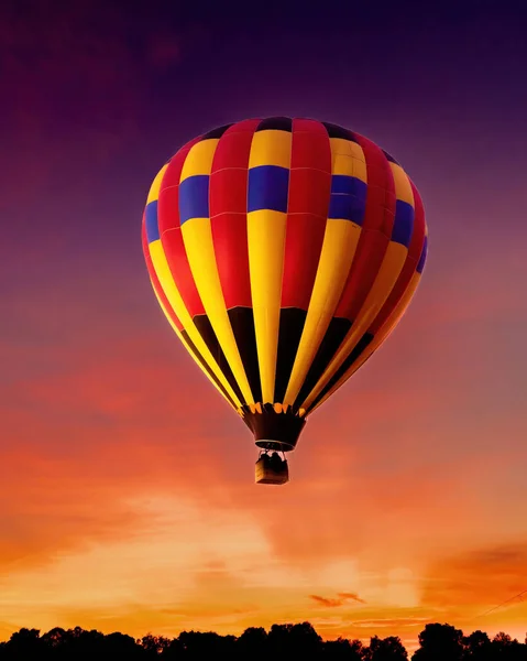 A beautiful shot of a hot air balloon in the air during sunset