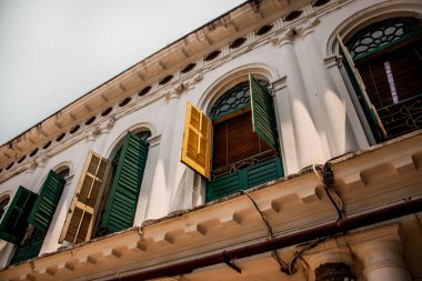 A low angle shot of the open windows of the Jorasako Thakurbari ancestral home in Kolkata, India