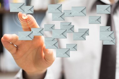 A businessman touching email icons in white background