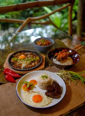 Delicious dishes served for breakfast or lunch (meat, potatoes, fried vegetables and eggs)