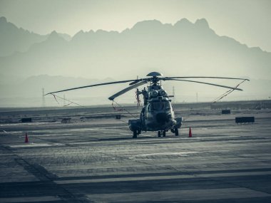 A closeup of a helicopter in the field