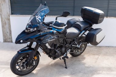 An angle shot of Benelli TRK 502 motorcycle parked outdoors.