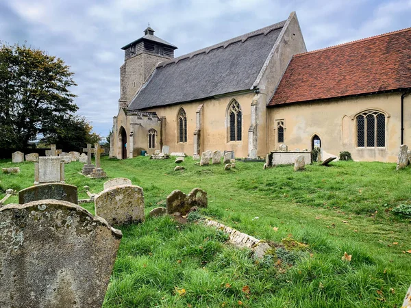 A low angle shot of a church in the village in Great Livermere, UK