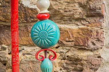 A closeup shot of a red, blue and white ornament decoration outdoors