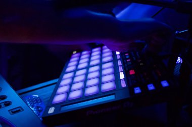 A male hand pressing a Studio Music Mixing Board Audio Digital Mixing with dark blue light