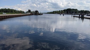 A scenic view of clouds reflecting in the water