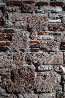 A vertical shot of a brick wall under the light