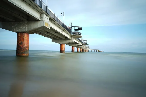a shot of a big bridge over the ocean on long exposure