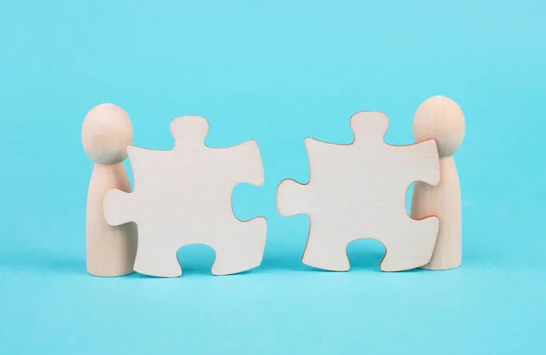 Two men with puzzle pieces built a team, connect the parts together, corporate in teamwork, communication and support concept