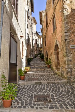 A narrow alley between the old houses of the medieval village of Giuliano di Roma