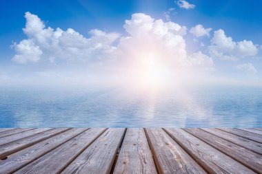 A beautiful shot of the sun hiding behind the clouds over a seascape