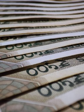 A vertical shot of piled banknotes - business investment concept