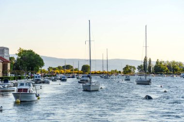 Several white boats moored on the Cetina river in Omis, Croatia