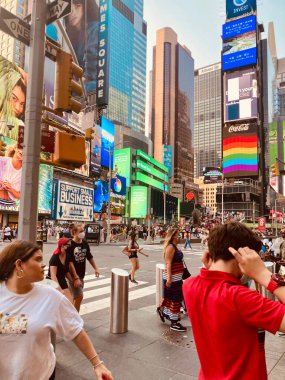 A vertical shot of people walking in Times Square in New York