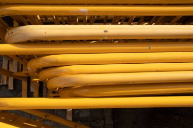 A top view of a number of yellow, metal moving gates outdoors in a daylight