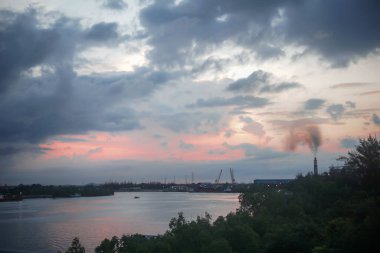 A mesmerizing view of a lake with orange sunset above it