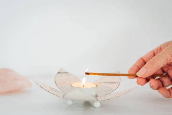 Hand Putting Flame Candle Incense Blurred White Background — Stock Photo, Image