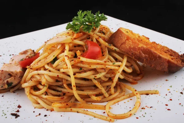 Closeup Spicy Italian Spaghetti Bolognese Cherry Tomatoes Greens Bread Slice — Zdjęcie stockowe