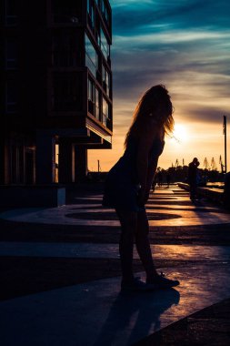 A silhouette of woman during summer sunset