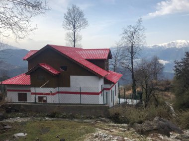 Beautiful house on hill in north part of India in winter time background hills covered with sn