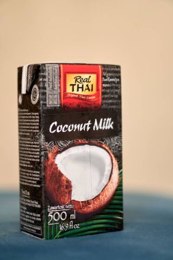 A vertical shot of a real Thai brand coconut milk in a box on a table