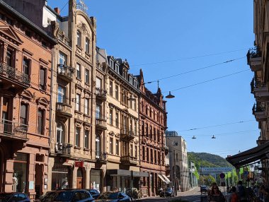 A scenic view of street lanterns hanging between house rows on power cables in Heidelberg, Germany