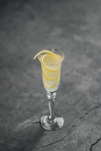 French Champagne Cocktail Lemon Twist Garnish Flute Glass Rustic Concrete — Foto Stock
