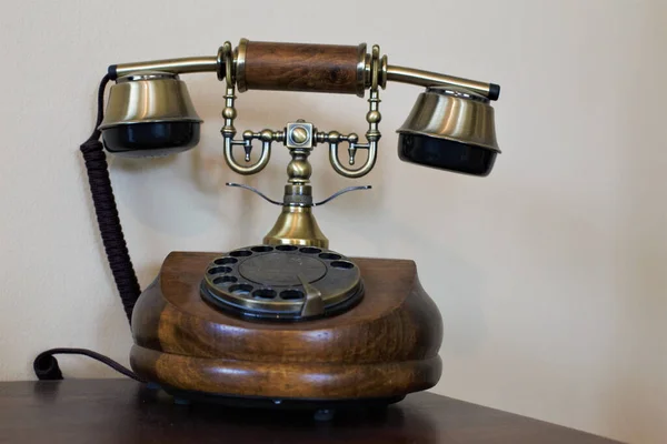 A vintage old wooden telephone on a table