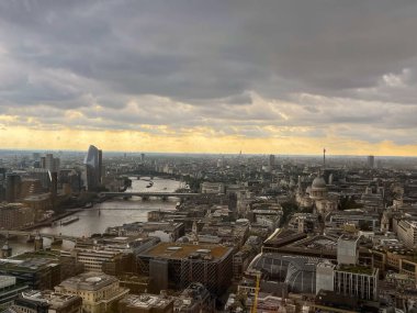 An aerial shot of a cityscape of a Central London at the sunset on a gloomy day