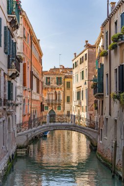 A vertical shot of Bridge of Sighs and the river with buildings in Gondola, Venice, Italy