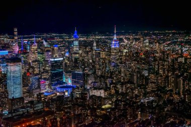 A mesmerizing view of the illuminated skyscrapers at night in New York City