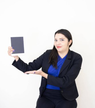 A young Hispanic executive female presenting information with a tablet