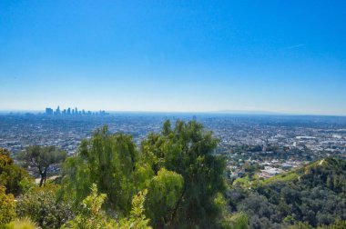 A urban panorama with high-rise buildings and blue skies on the background