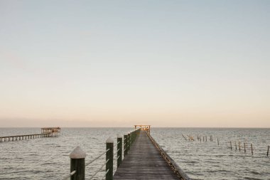 A scenic view of wooden piers on the seascape on a sunny day in Fairhope, Alabama