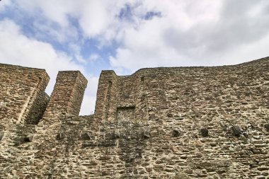 A low angle shot of the Ruins of the Lowenburg castle in Monreal Eifel in Germany with a blue cloudy sky