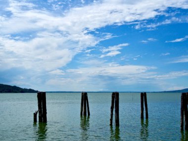beautiful sky reflecting on trasimeno lake in central italy on a hot summer afternoon