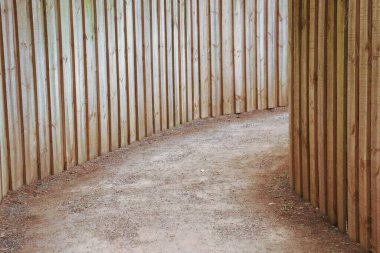 outdoor dirt walking path lined with timber boards